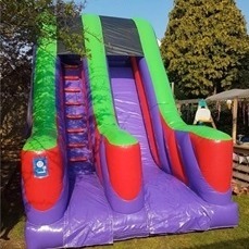Monster Inflatables A colourful inflatable slide in garden setting