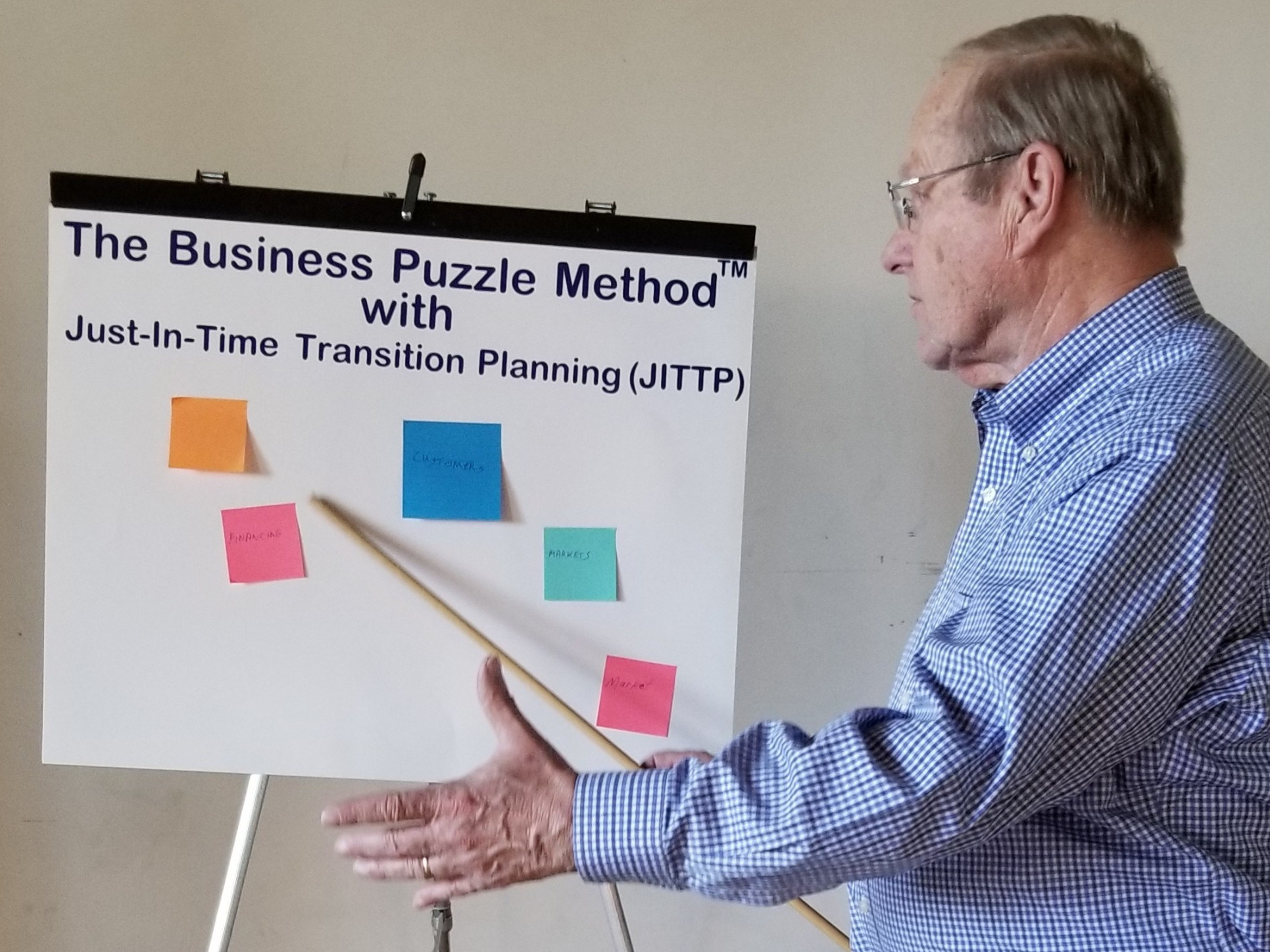 resilience planning, focused expression, drafting plans on a whiteboard, photorealistic, modern office space with large windows, highly detailed, papers scattered subtly, bokeh effect, neutral color palette, ambient lighting, shot with a 35mm lens.