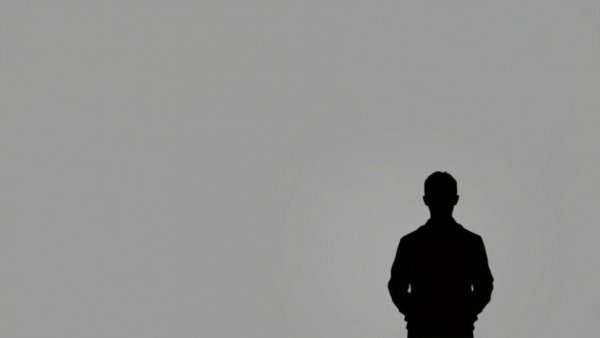 Minimalist silhouette on gray background with neutral expression.