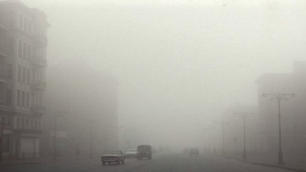 Impact of Air Pollution on Human Health: 1960s smoggy city street.