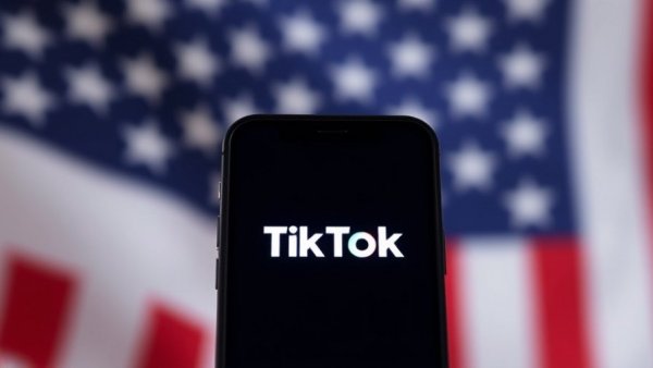 TikTok logo on phone with American flag background; privacy policy changes.