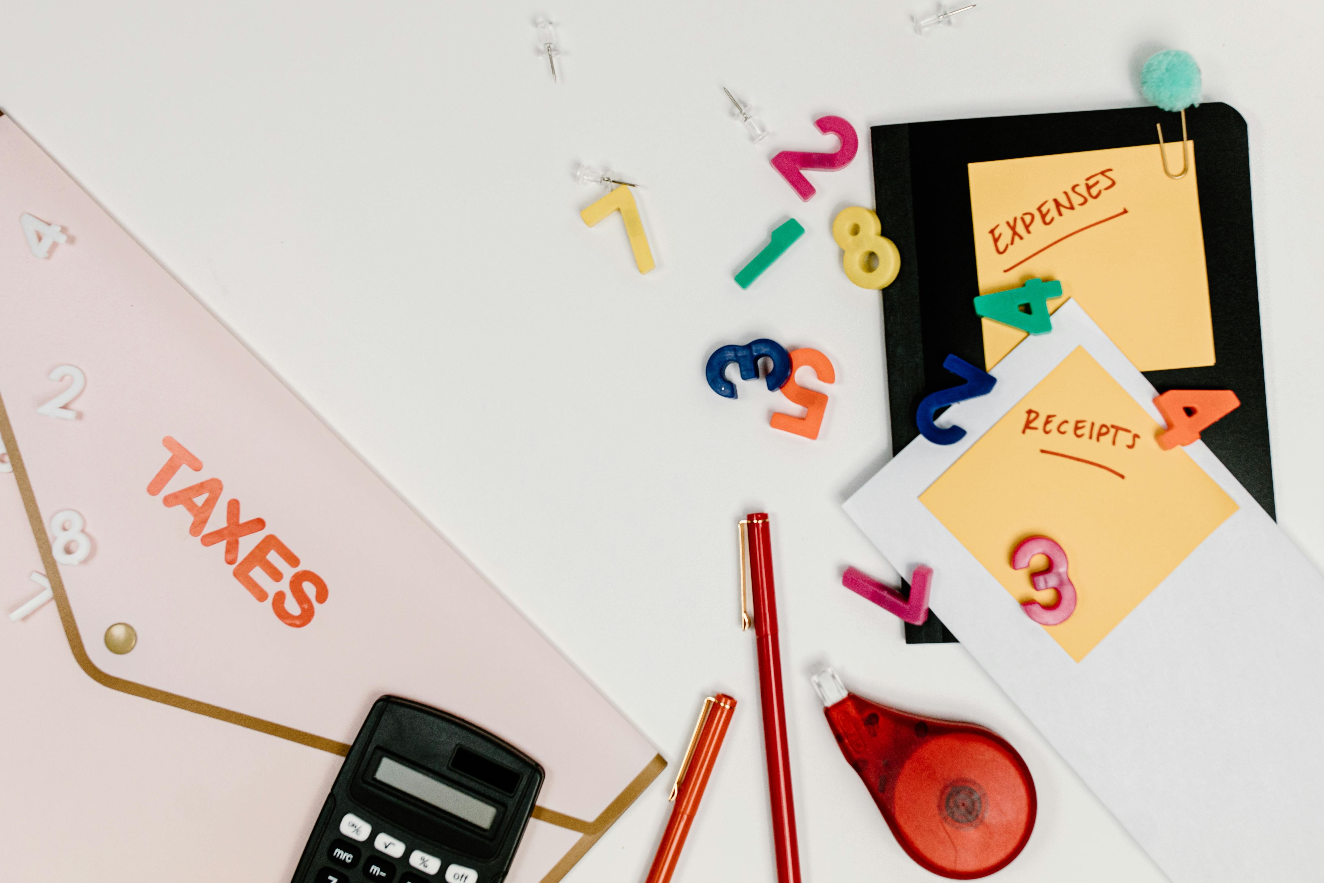 Calculating tax strategy for small businesses with a laptop and documents.