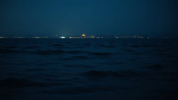 Nighttime seascape at Texas City Dike with gentle waves