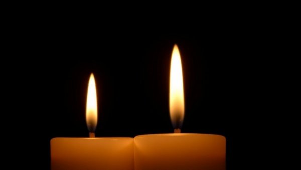 Candles flickering gently in darkness, symbolizing remembrance for Peter Greene dies at 60.