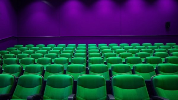 Vibrant theater seats and purple wall highlighting color contrast.