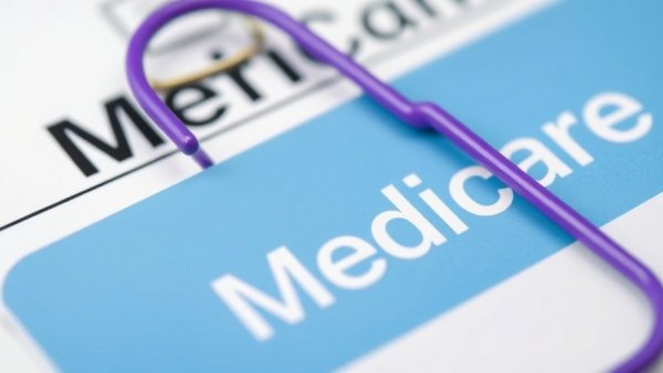 Close-up of Medicare card and document, highlighting Medicare Advantage overpayments.