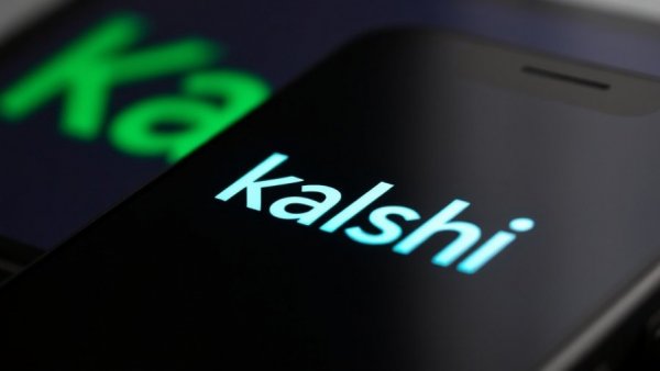 Close-up of Kalshi app on smartphone with green logo; emphasis on digital branding.