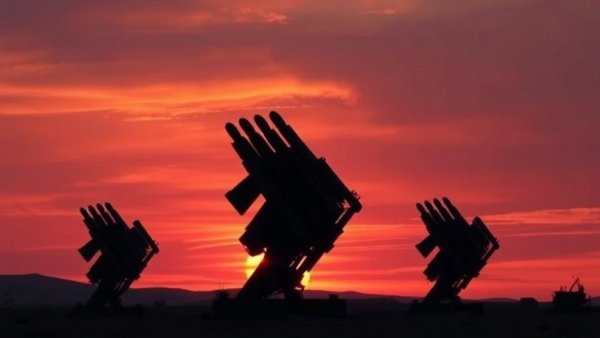 Iran missile attack concept with missile launchers and flag at sunset.