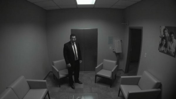 CCTV footage related to Dallas crime news in an interrogation room.
