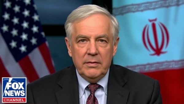 Broadcast discussing US military readiness warnings with flags of US and Iran.