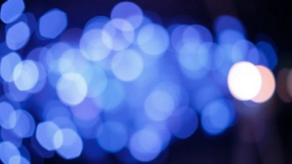 Impact of domestic violence on children illustrated with abstract blue and purple bokeh.