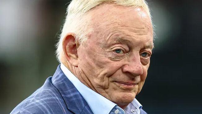 Man discussing Dallas Cowboys picks 12 and 20 in indoor setting.