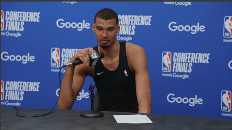 San Antonio Spurs player at press conference expressing excitement.