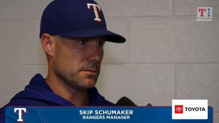Texas Rangers manager interviewed about road struggles in hallway.