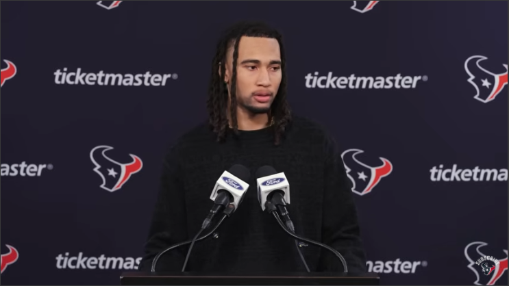 C.J. Stroud at Houston Texans press conference smiling confidently.