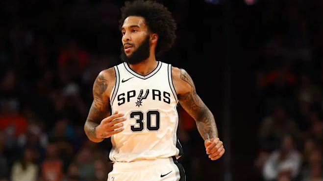Spurs player smiling during post-game interview, capturing NBA game recap highlights.