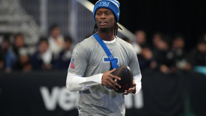 Football player in action amid franchise tag news on field.