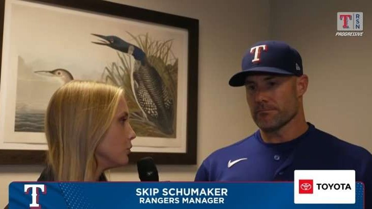 Baseball manager interview in front of artwork with journalist