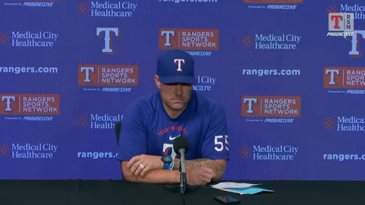 Baseball player's pensive expression at press conference discussing first inning struggles.