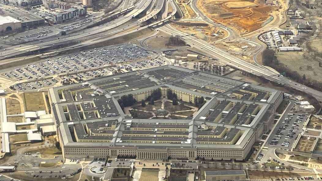 Pentagon press briefing on access policy with two officials at podiums.