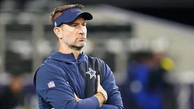 Football coach with Cowboys logo, demanding head coach change.