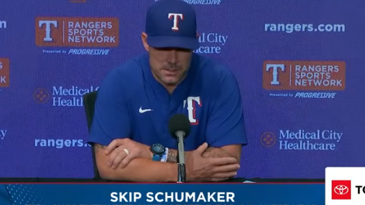 Kumar Rocker sitting at a press conference table for Skip Schumaker and Kumar Rocker interview.