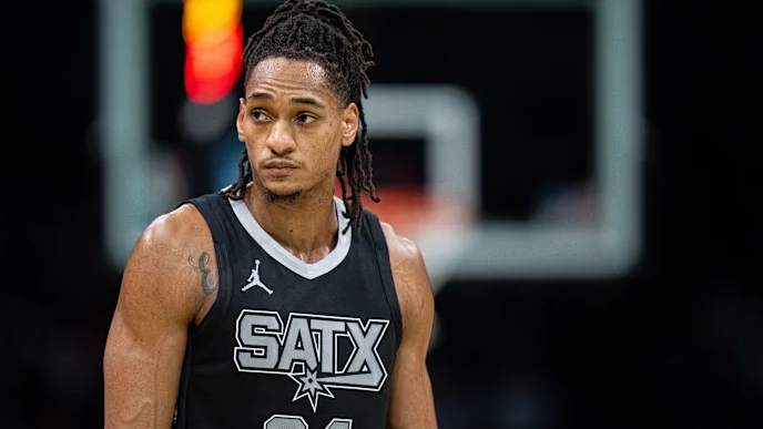 San Antonio Spurs game action with player showing determination.