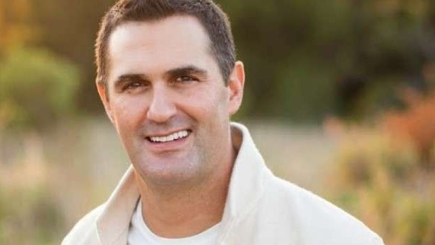 Man smiling outdoors, Dallas venture capital theme