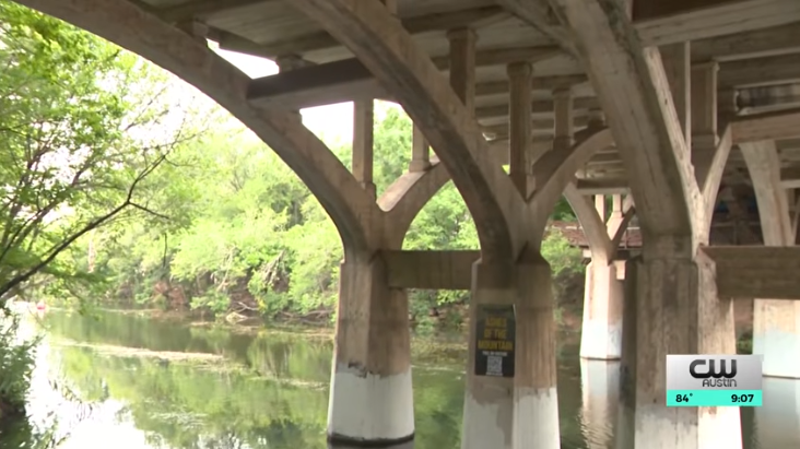 Austin news highlights a sign reading 'This Bridge Was Built to Last'.