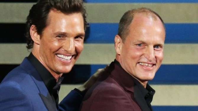 Matthew McConaughey and Woody Harrelson smiling at an event