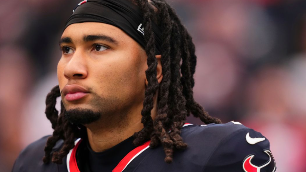 Houston Texans player at press conference in front of logo, speaking.