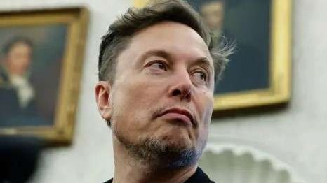 Confident man in black suit at formal event, Terafab facility.