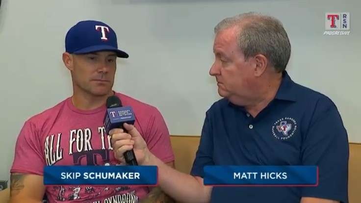 Casual indoor baseball interview with two men discussing.