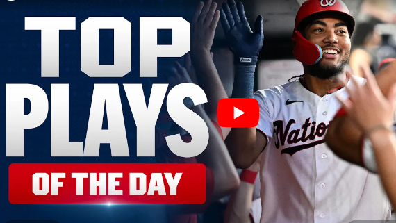 Baseball player in Nationals uniform celebrates with teammates in dugout
