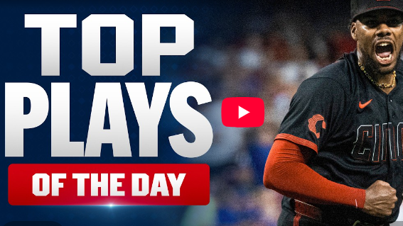 Baseball player in dark uniform celebrates on the field