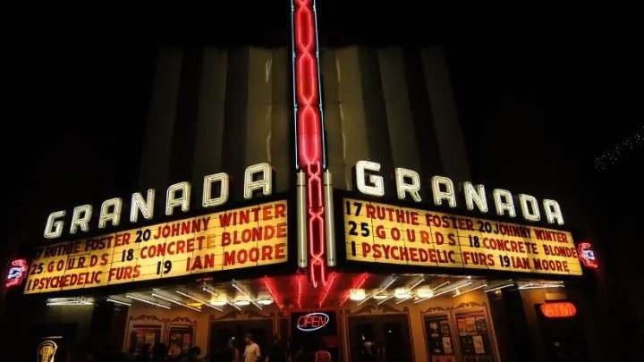 Granada Theater at night with people gathered outside