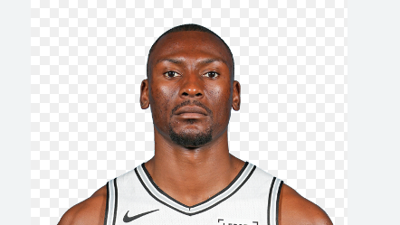 Bismack Biyombo cancer awareness hospital visit, smiling with patient.