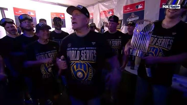 Milwaukee Brewers fans celebrating World Series win indoors.