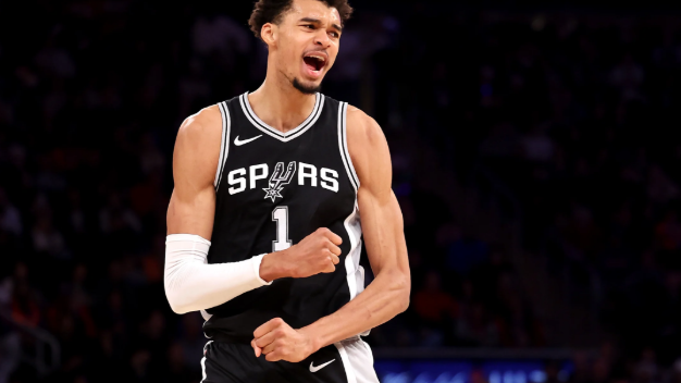 San Antonio Spurs highlights intense game scene with dramatic jump shot.