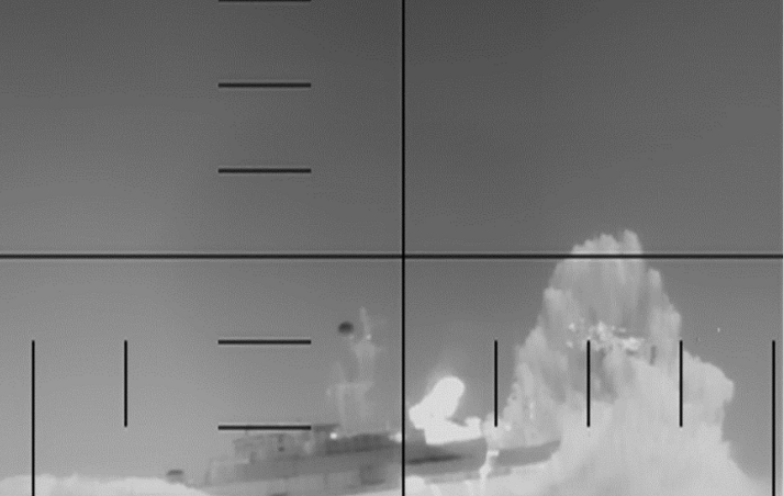 Missile debris submerged in water amid dry vegetation.