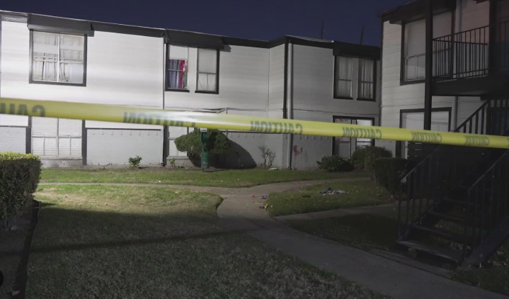 Sad black residents in a housing project, highlighting houston community safety concerns.