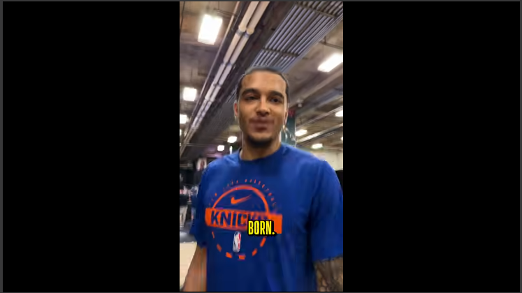 Knicks fan celebrating on basketball court, vibrant arena setting.