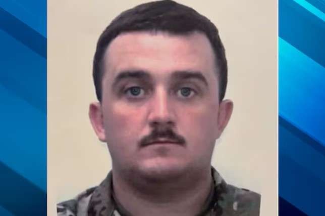 Military personnel in uniform with stern look, National Guardsman recovery update.