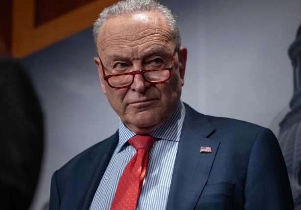 Serious older man in government building during shutdown discussion.