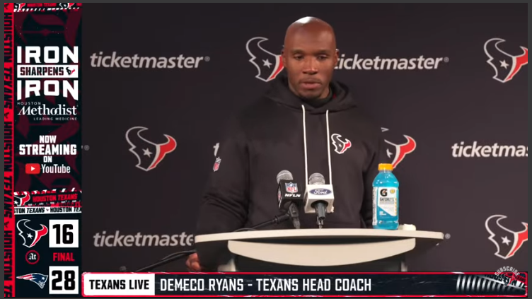 Texans coach discussing defensive strategies at a press event, Texans defensive struggles