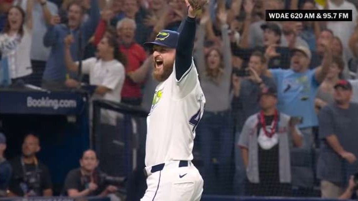 Tampa Bay Rays celebrating victory on baseball field, energetic atmosphere.