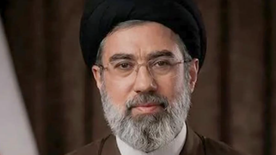 Mojtaba Khamenei influence depicted with portraits and dramatic fire scene.