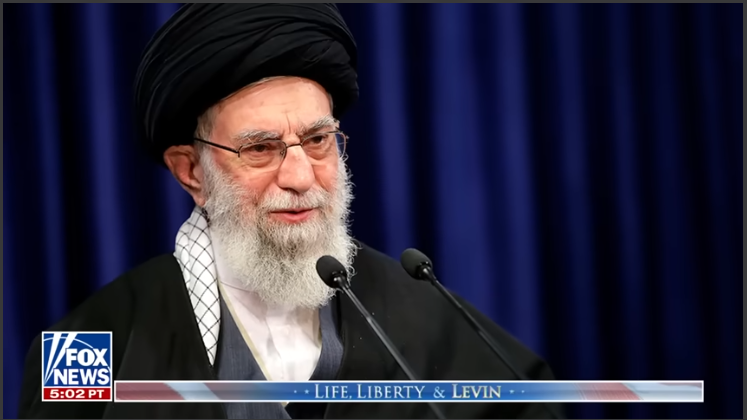 News host discussing U.S.-Iran tensions diplomacy in studio setting.