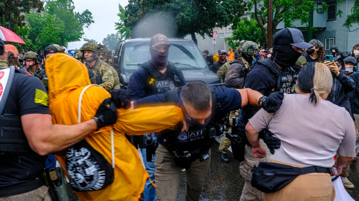 Trump Insurrection Act Minnesota: Man at desk in thoughtful pose.