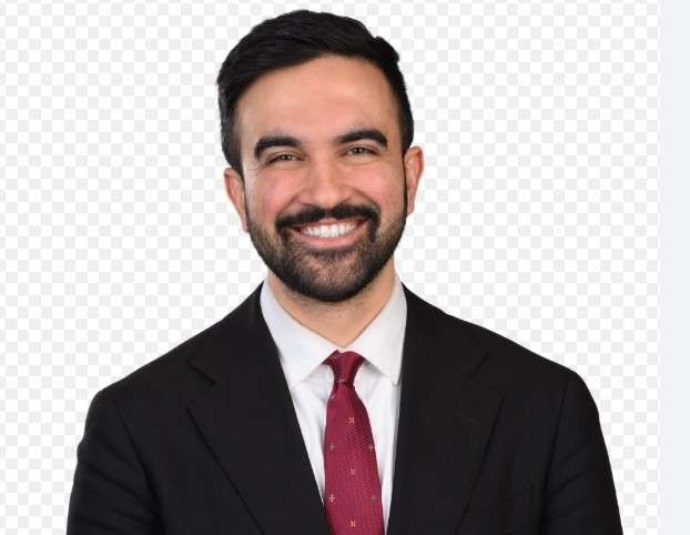 Democratic Party news: Charismatic man smiling at urban event.